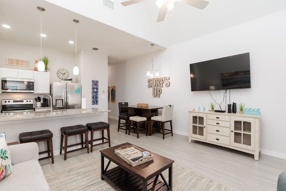 Relax in your bright, modern open-concept space featuring a fully equipped kitchen, cozy dining area, and entertainment center perfect for unwinding.