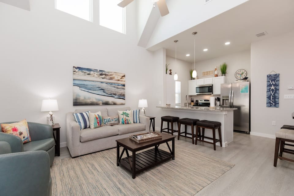 Relax in your bright, airy living space with soaring ceilings and coastal-inspired décor that invites you to unwind completely.
