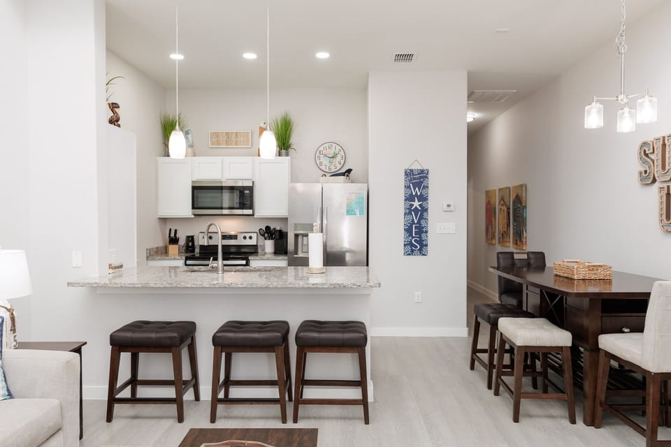 Step into your modern open-concept space where the sleek kitchen flows seamlessly into your dining area, perfect for morning coffee or evening meals.