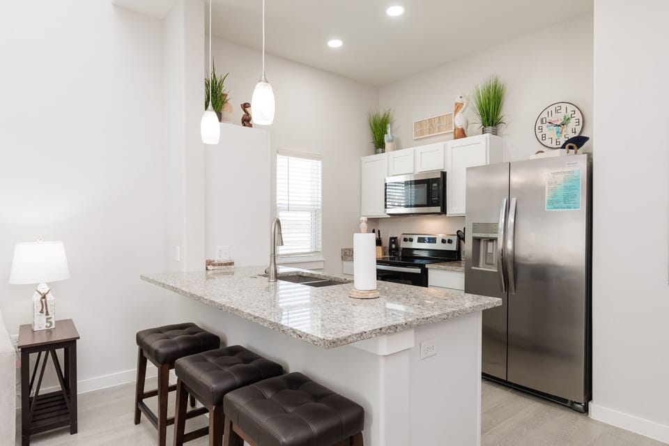 Your modern kitchen features granite countertops, stainless steel appliances, and stylish pendant lighting for memorable meal prep.