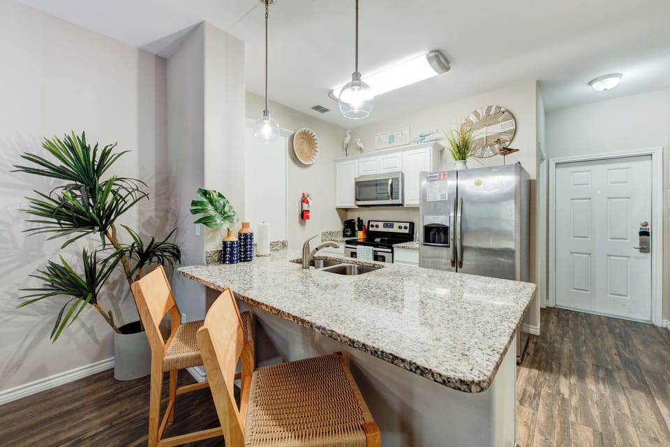 Your modern kitchen features granite counters, stainless appliances, and stylish pendant lighting perfect for cooking memorable meals together.