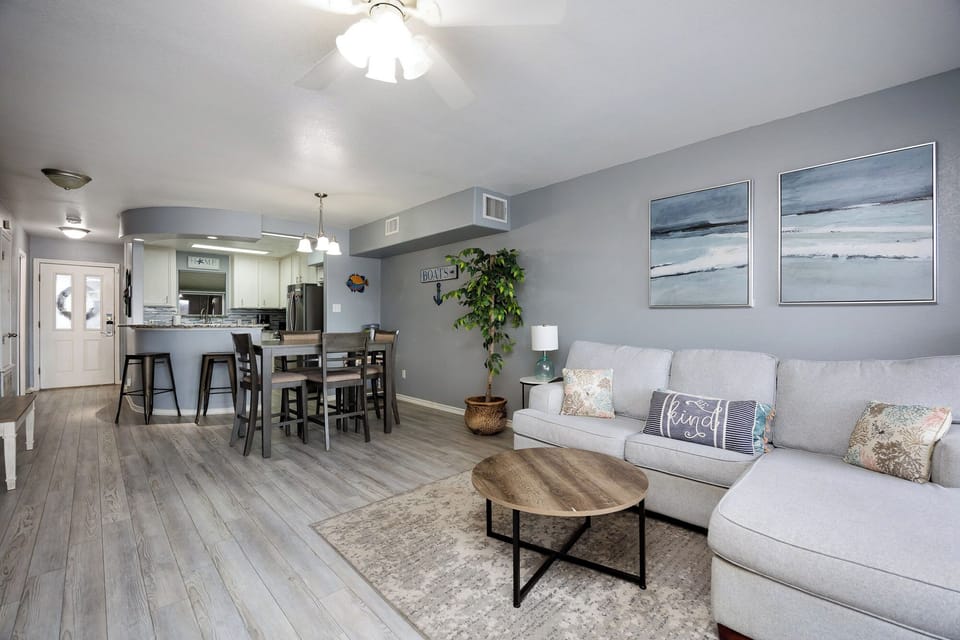 Unwind in your coastal-inspired living space where ocean artwork and soft furnishings create the perfect retreat for relaxation.