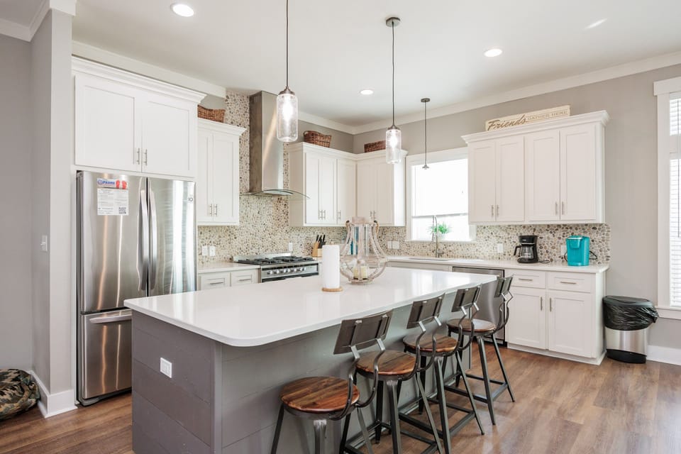 Your modern kitchen awaits with gleaming countertops, stainless appliances, and cozy bar seating where morning coffee tastes even better.