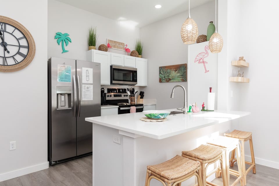 Cook your favorite meals in this bright, fully-equipped kitchen featuring modern appliances and tropical touches that make you feel right at home.