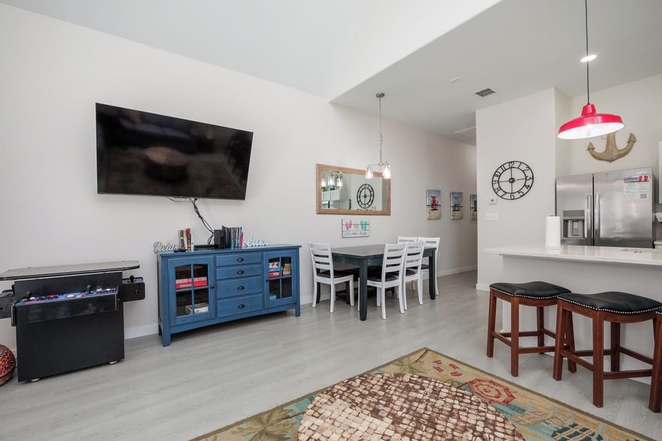 Your spacious living area combines comfort with coastal charm. Relax on the soft rug while enjoying your favorite shows on the large TV.