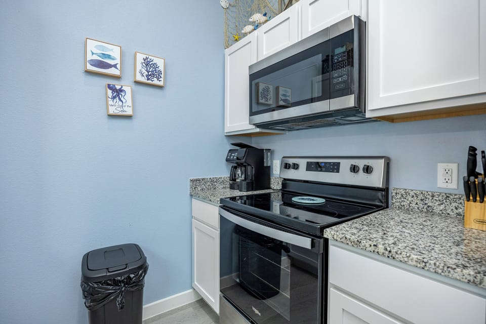 Your fully equipped kitchen features modern appliances and coastal-themed touches, making meal prep a breeze during your stay.