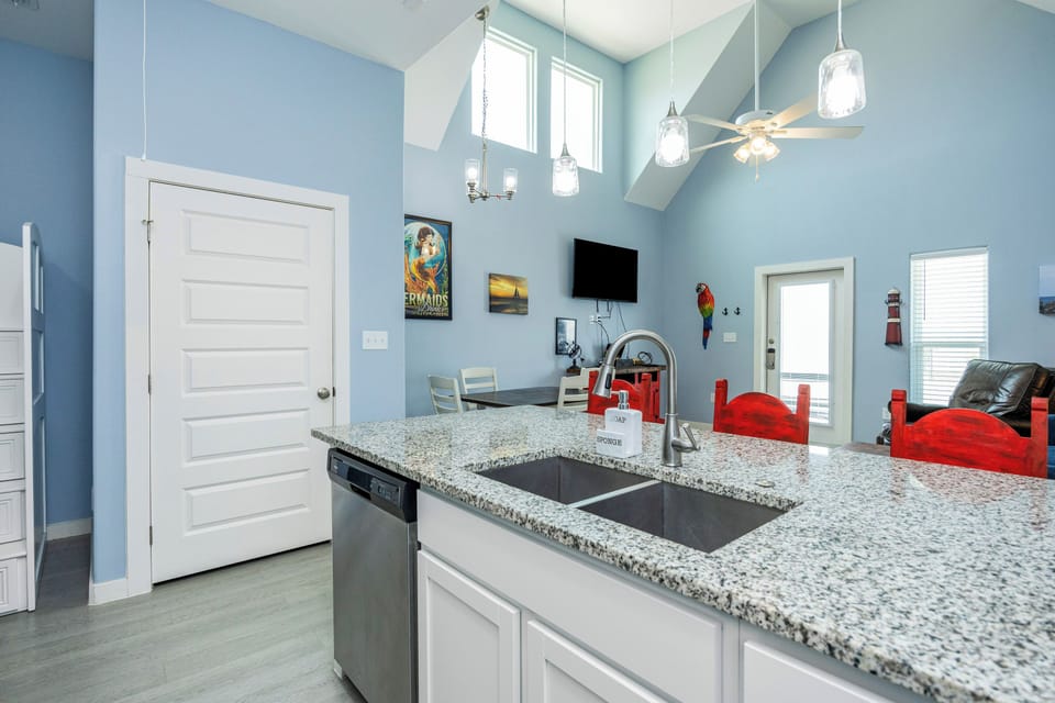 Your modern kitchen features gleaming granite countertops, stainless appliances, and bright pendant lighting—perfect for preparing meals together.