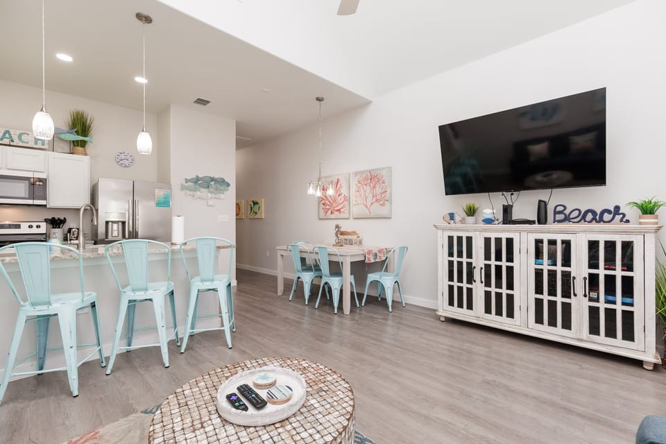 Relax in your bright, beach-themed living space with modern kitchen, cozy dining nook, and coastal décor throughout.