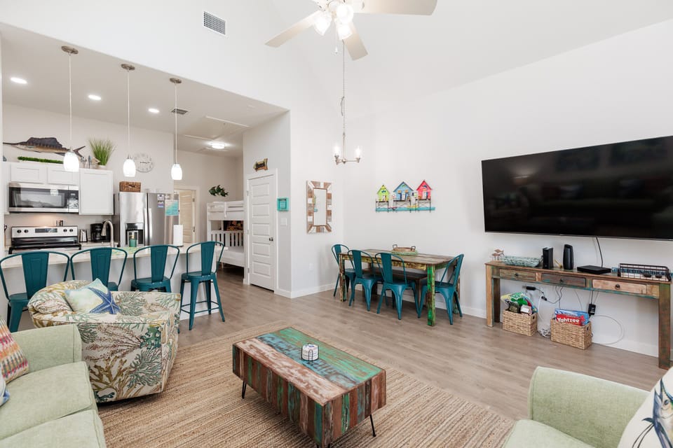 Relax in your bright open-concept space with stylish coastal furnishings, modern kitchen, and entertainment center for memorable family gatherings.