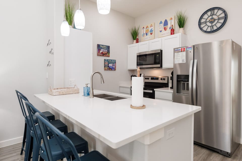 Your fully-equipped kitchen features modern appliances and a spacious island perfect for cooking meals and gathering with loved ones during your stay.