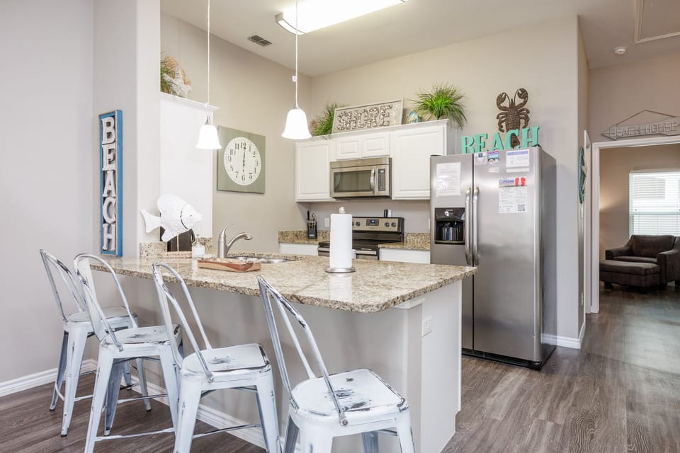 Your fully-equipped kitchen island becomes the heart of the home, perfect for morning coffee and casual meals together.