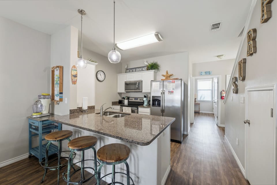 Step into your fully equipped kitchen with a spacious island and bar seating—perfect for gathering with loved ones or starting your mornings with fresh coffee in hand.