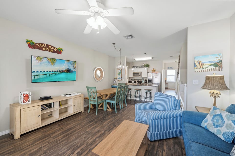 Relax in your open-concept living space, where ceiling fans keep you comfortable while you gather around the dining table or unwind on the sofa, with the kitchen just steps away for easy entertaining.