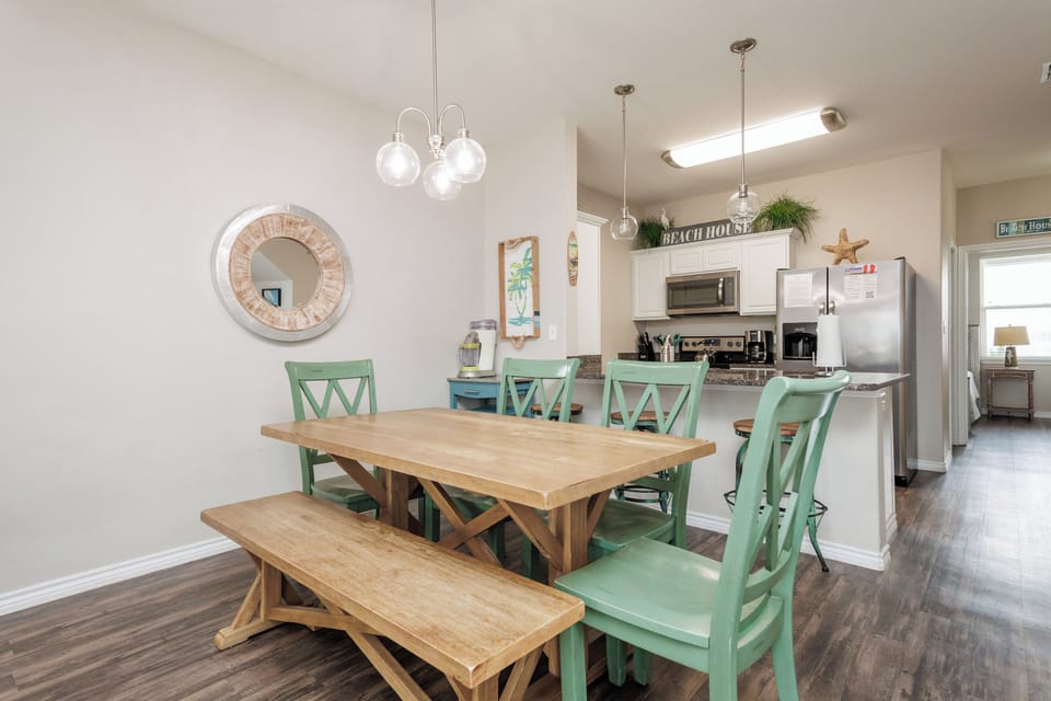 Gather around your spacious dining table where coastal charm meets comfort, creating the perfect spot for memorable meals together.