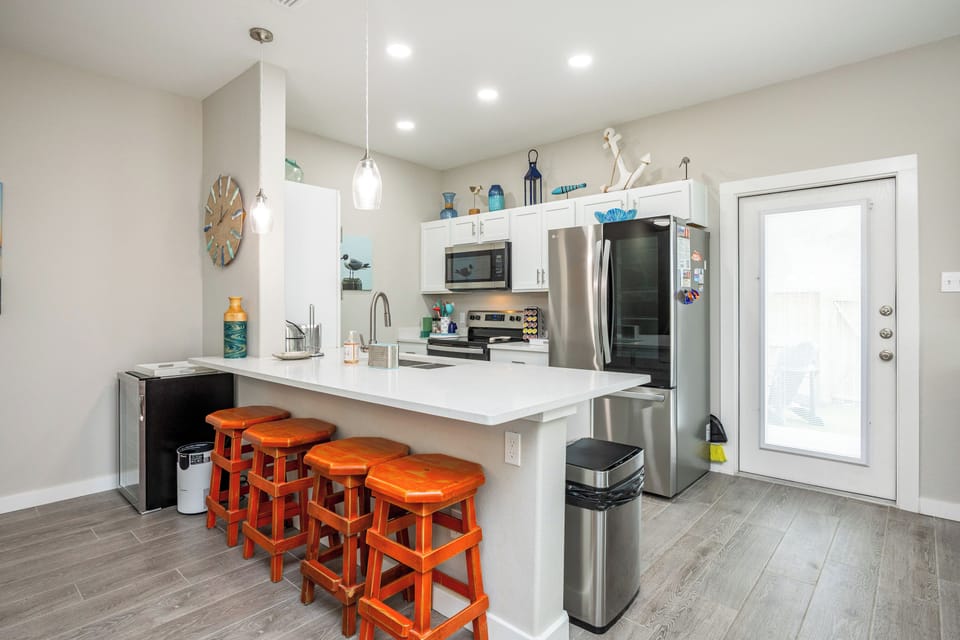Your fully equipped kitchen features stainless steel appliances and a breakfast bar where you can enjoy morning coffee.