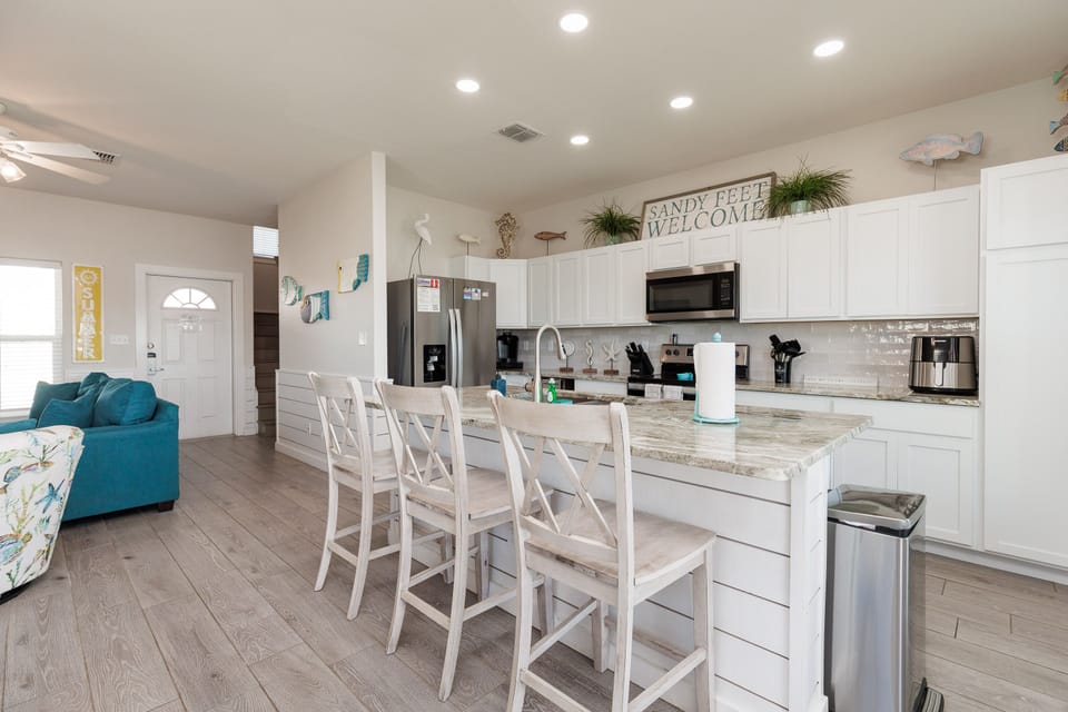 Your bright, open kitchen features granite counters and stainless appliances, perfect for preparing meals while chatting with family at the breakfast bar.