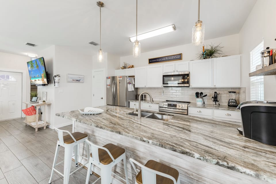 Your gourmet kitchen features stunning granite countertops, stainless steel appliances, and a spacious island perfect for morning coffee or meal prep.