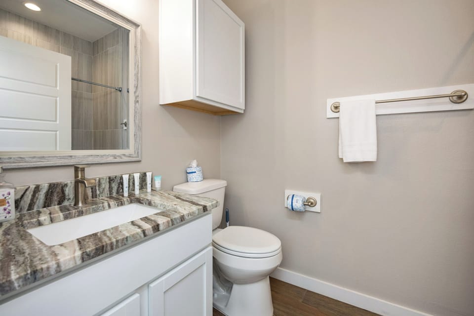 Your private bathroom features elegant marble countertops, modern fixtures, and fresh linens waiting for your arrival.