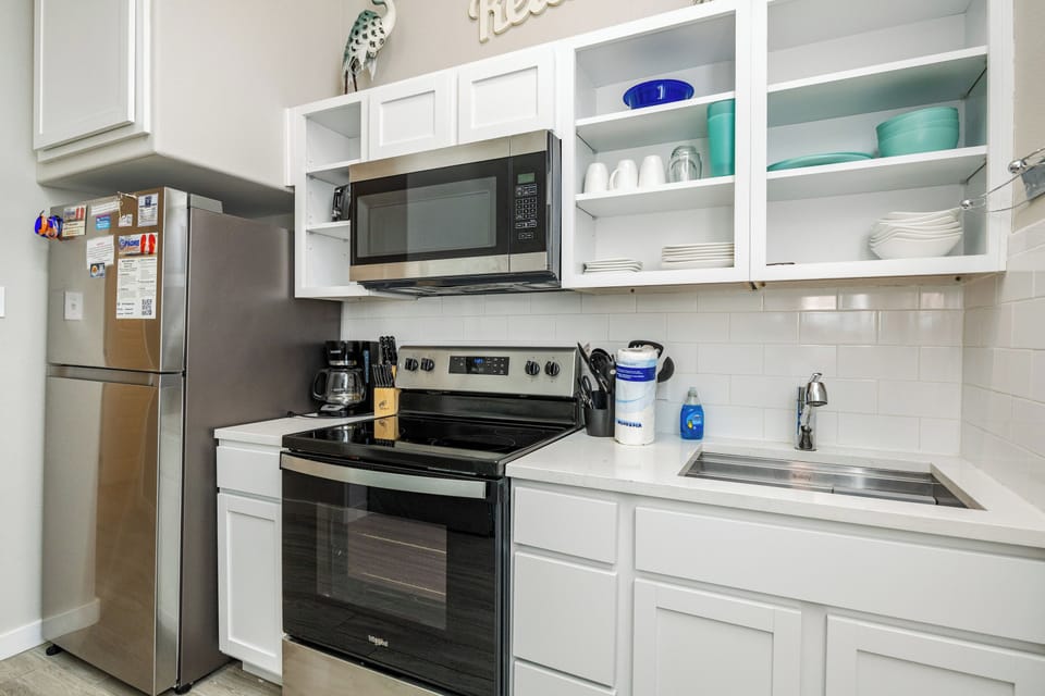 Your bright kitchen offers everything for memorable meals: modern appliances, crisp white cabinetry, and thoughtful touches ready for your arrival.
