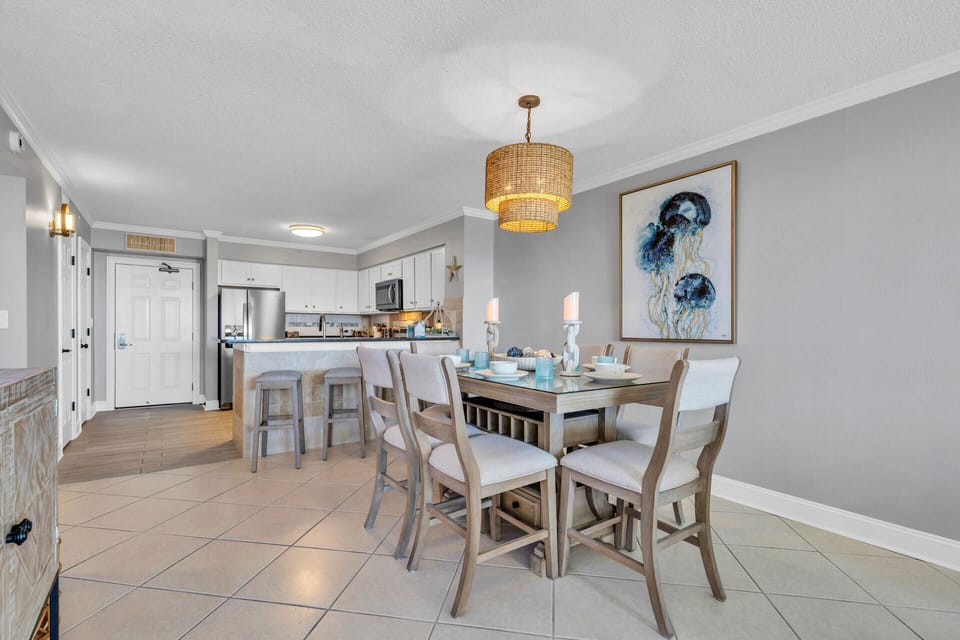 Your stylish dining space features coastal charm with a woven pendant light and elegant table perfect for memorable meals together.