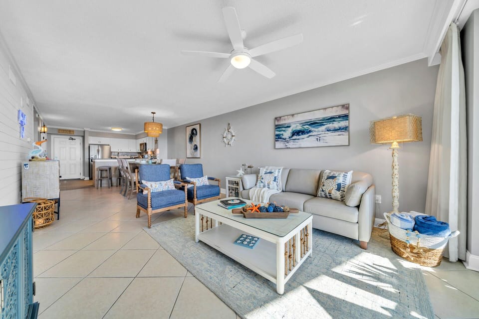 Unwind in your coastal-inspired living room where ocean blues meet comfortable grays, creating the perfect space for relaxation.