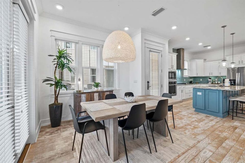 A spacious, open kitchen and dining area with stylish fixtures and high-end finishes, perfect for entertaining guests.