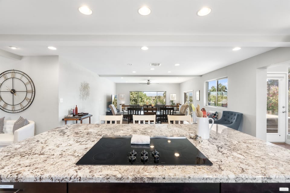 Kitchen with bar seating, granite counter tops, hardwood floors, and state-of-the art appliances.