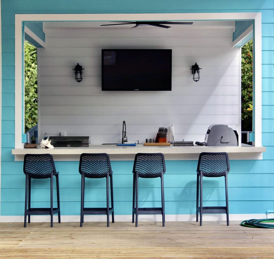 Counter seating with stools at the outdoor kitchen—perfect for entertaining.