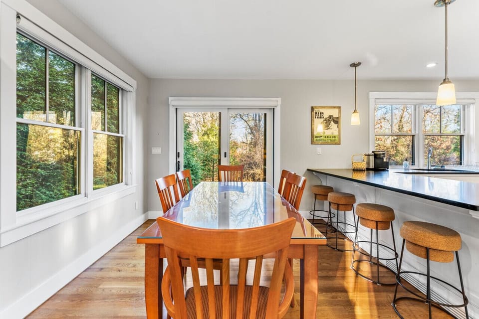 The dining space includes a large table suitable for accommodating six guests.