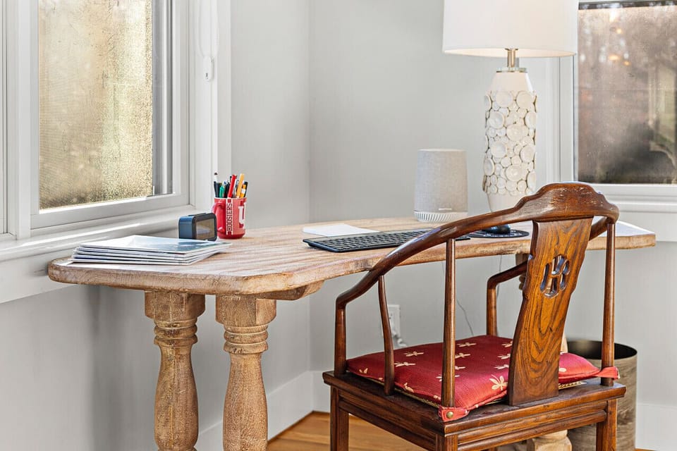 A workspace with a table and chairs in the second bedroom.