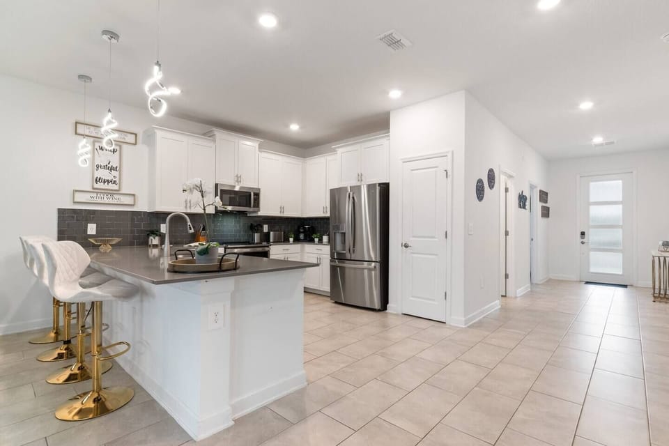 Kitchen with barstools and stainless steel appliance