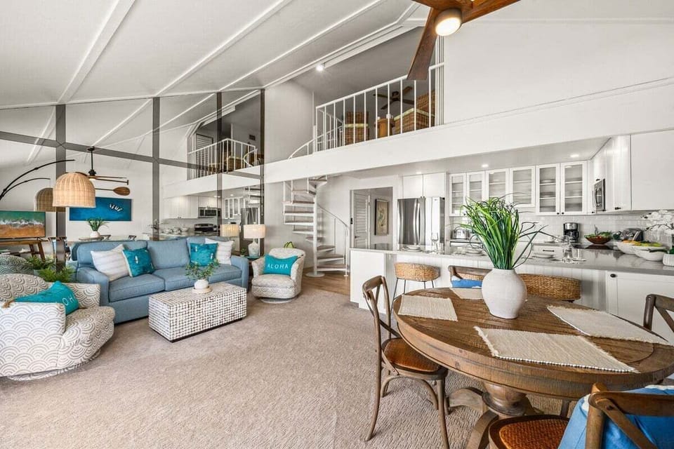 Beautiful living space featuring modern wicker seating, a stylish dining set, and a welcoming open layout