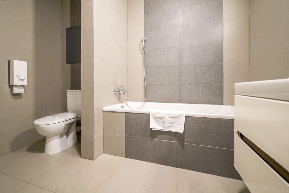 Vesna Convenient Apartment by CHORS | Bathroom | Bathtub, free toiletries, hair dryer, towels