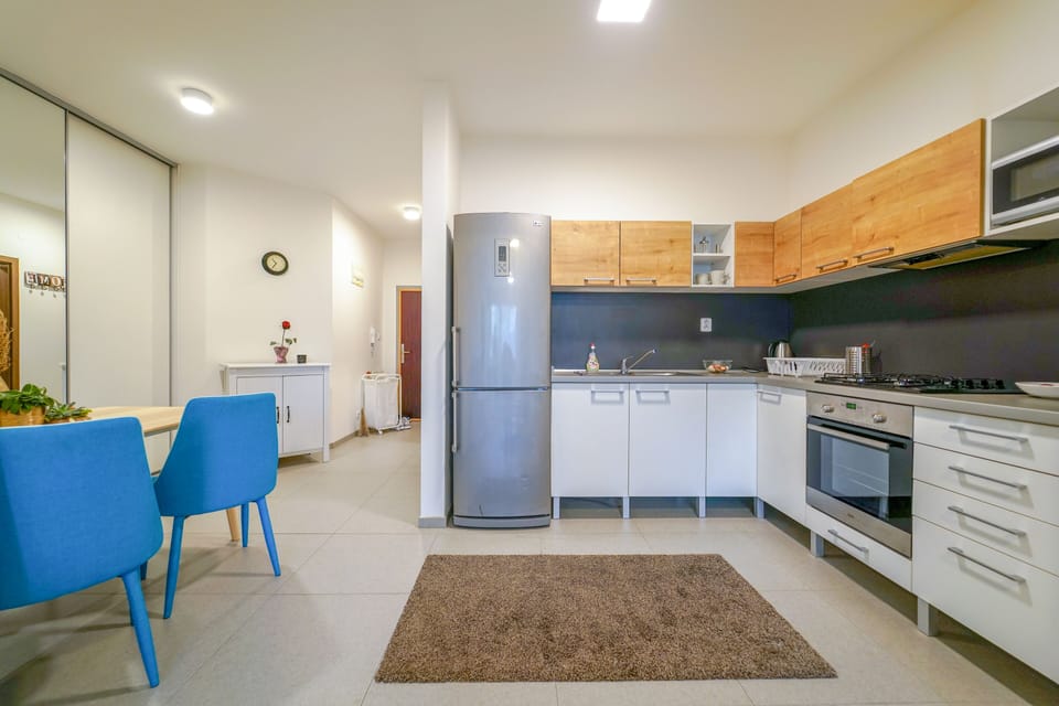 Vesna Convenient Apartment by CHORS | Private kitchen | Full-size fridge, microwave, stovetop, coffee/tea maker