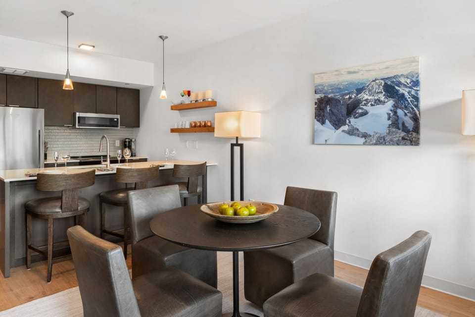 Dining area seats 4 guests and additional bar seating for 3.