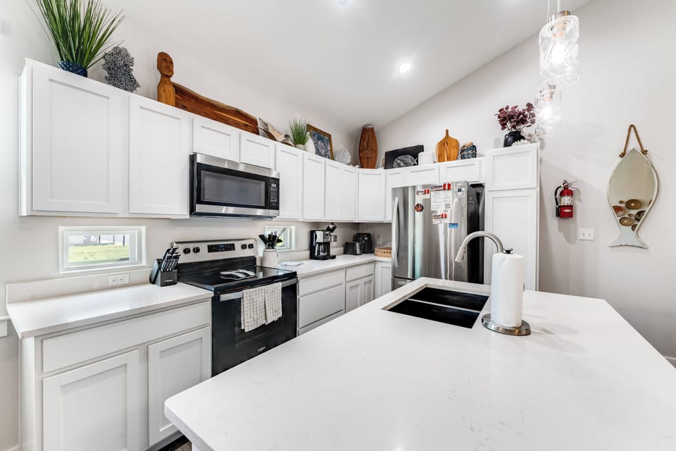 Your fully equipped kitchen features modern appliances, quartz countertops, and thoughtful touches that make cooking feel like home.