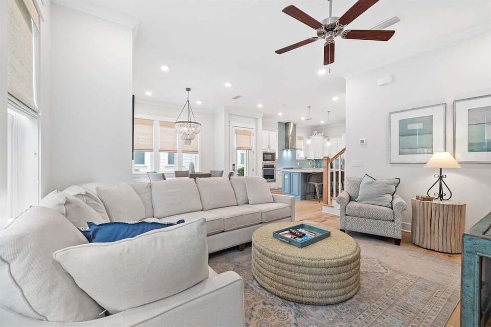 A beautifully designed open-concept living space with plush seating, modern decor, and plenty of natural light.