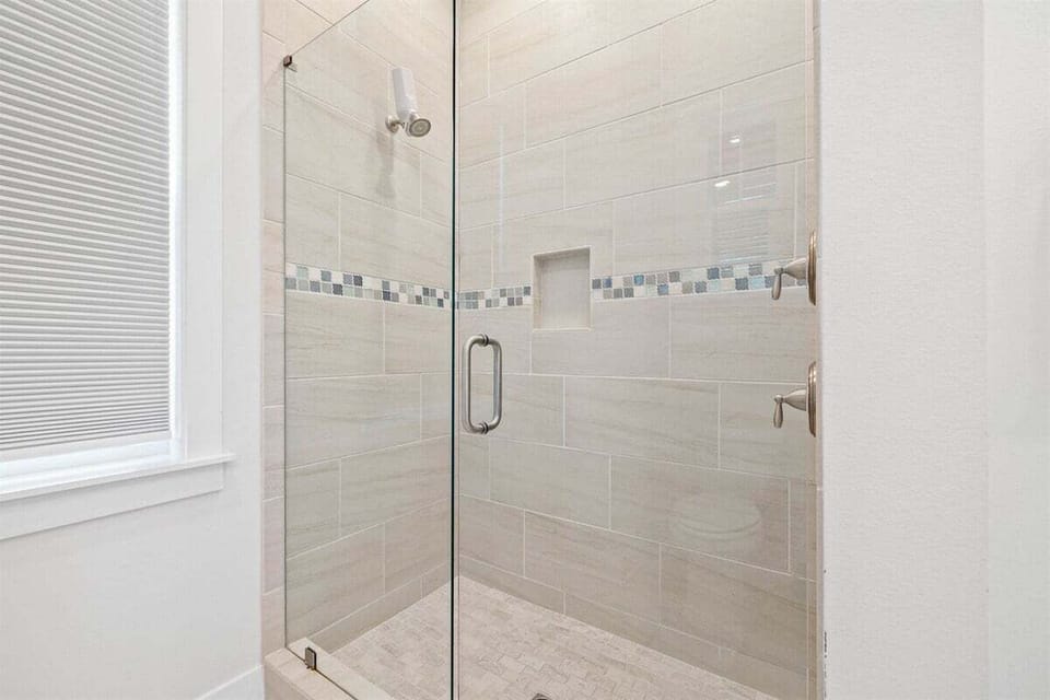 A spacious walk-in shower with stylish tilework and a spa-like feel.