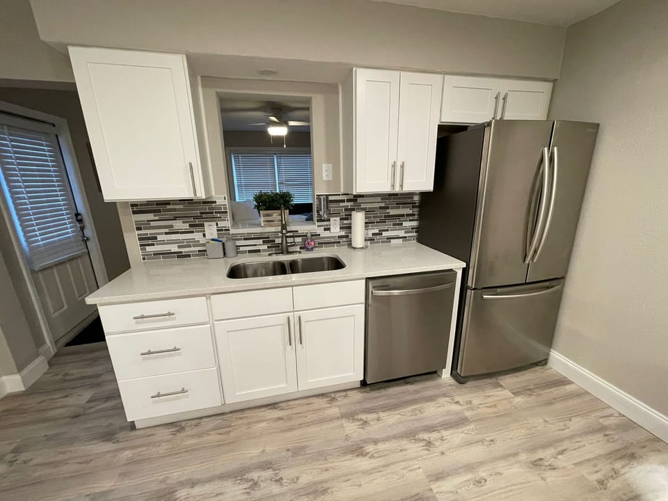 The open layout seamlessly integrates the kitchen with the dining area, creating a warm and inviting space perfect for entertaining guests or enjoying family meals.