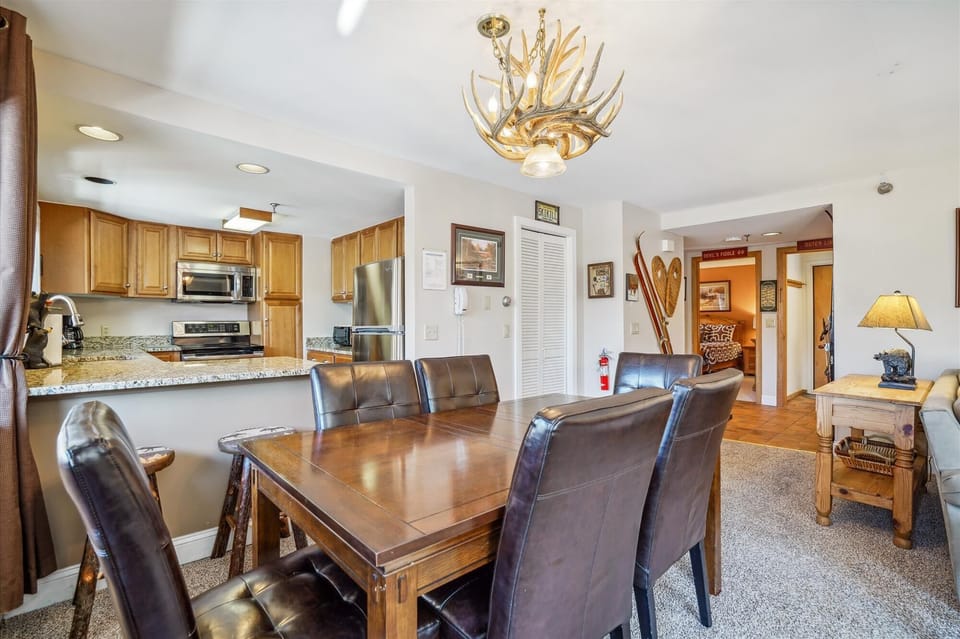 Comfortable open dining space with seating for family dinners, games, and après-ski nights.