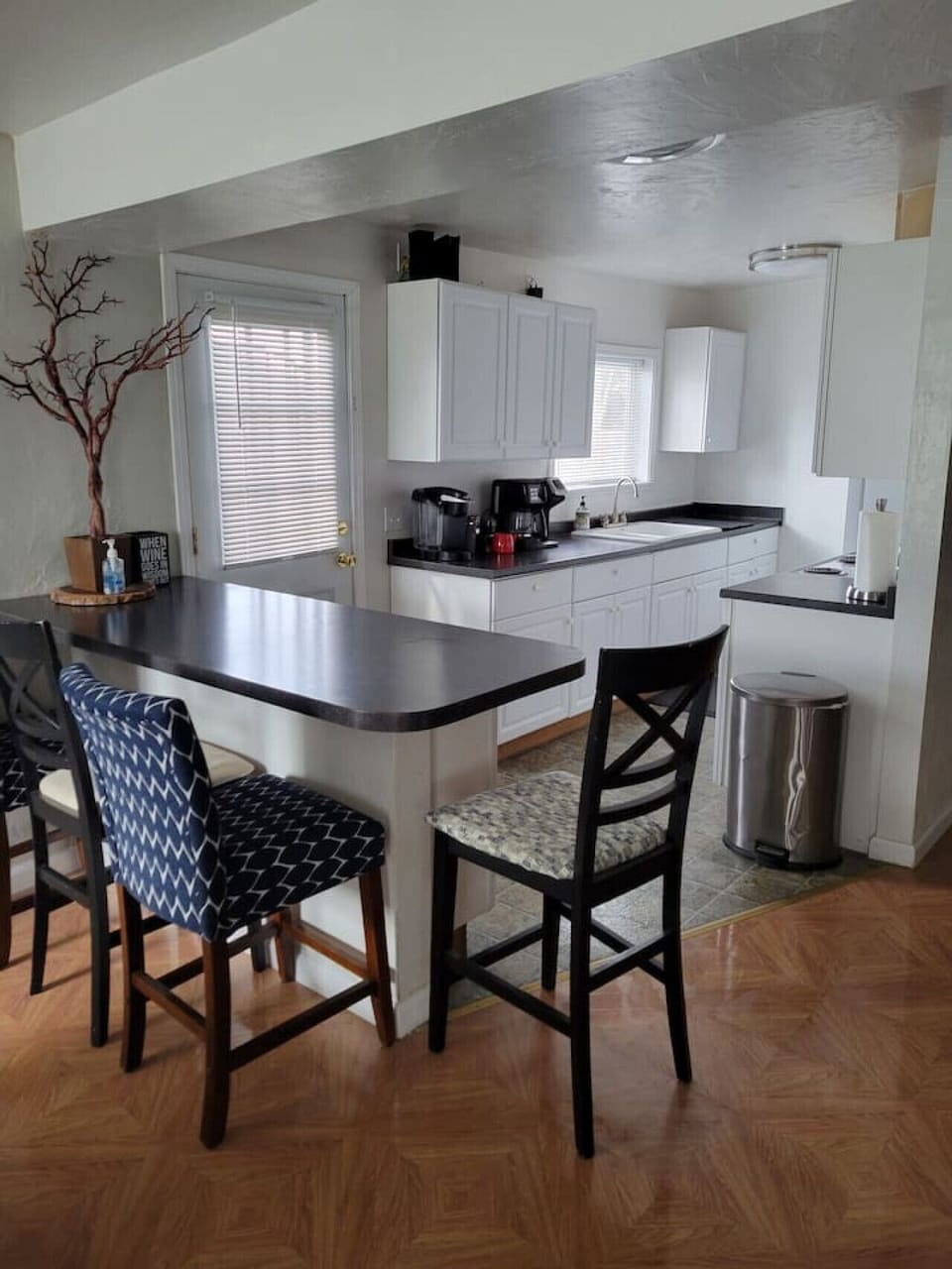 Fully equipped kitchen with breakfast bar seating and open layout to the dining area.