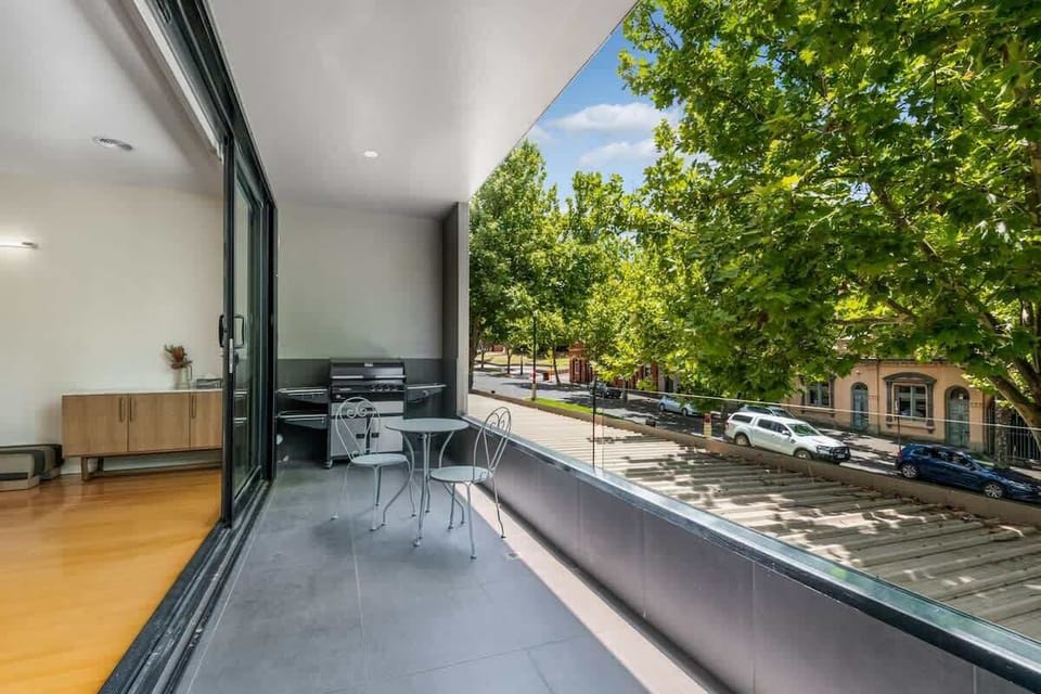 Balcony with BBQ and seating area.