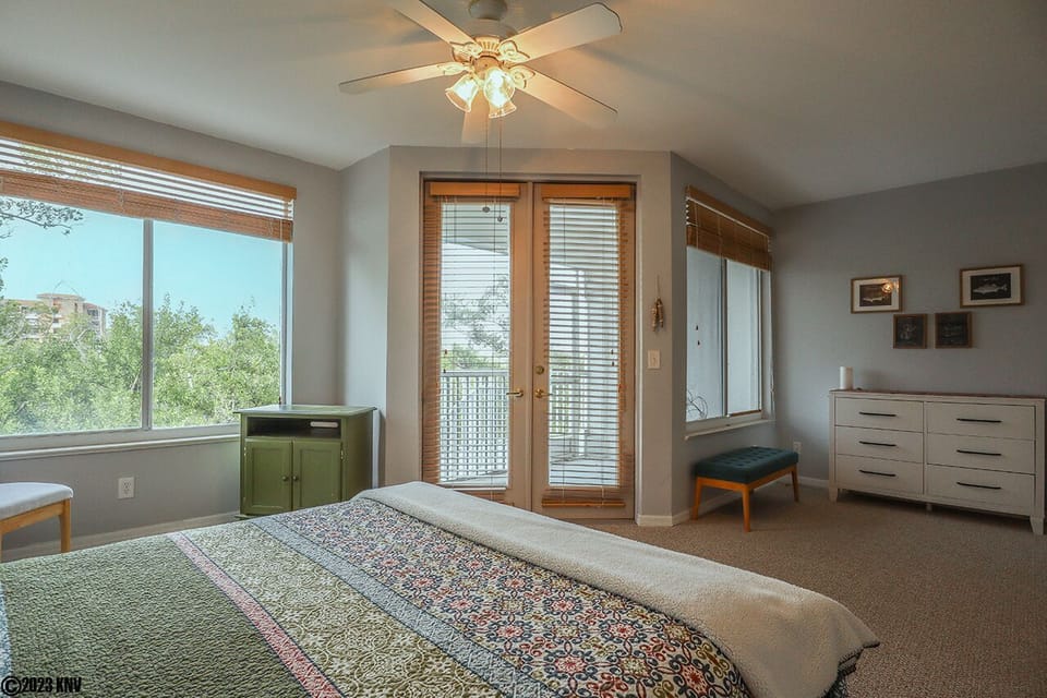 Large Windows and French Doors to private patio let in lots of sunlight