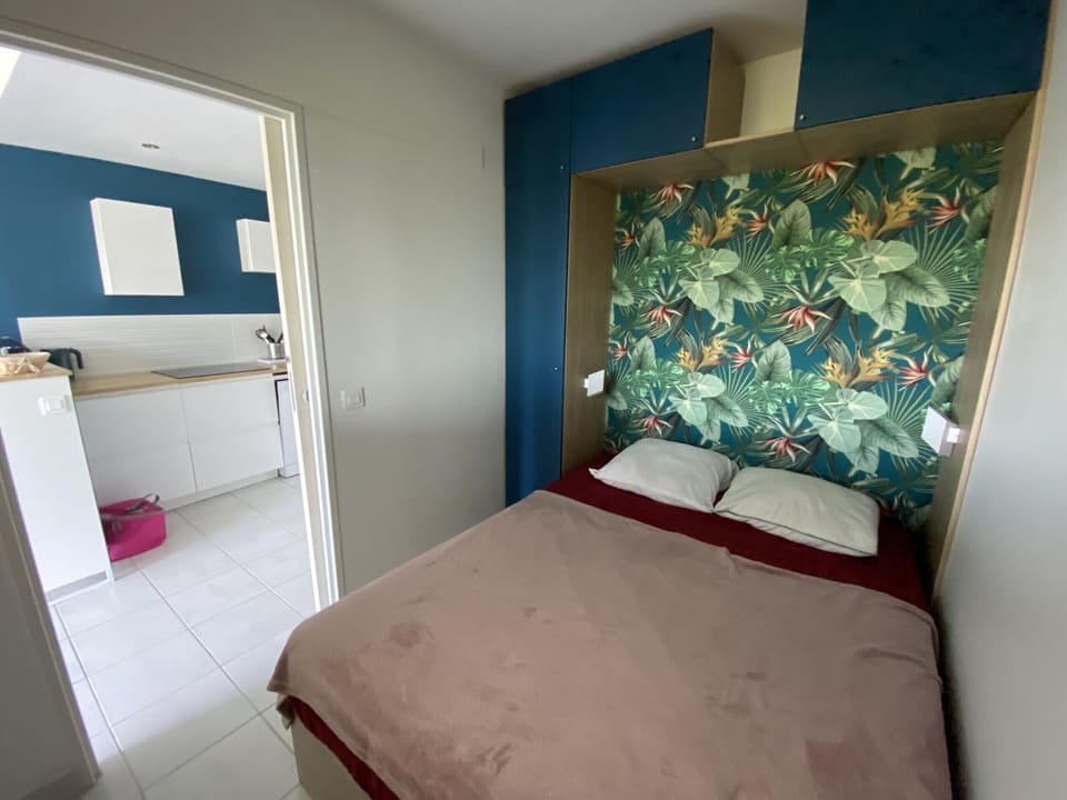 Modern room with a double bed, overlooking the living area