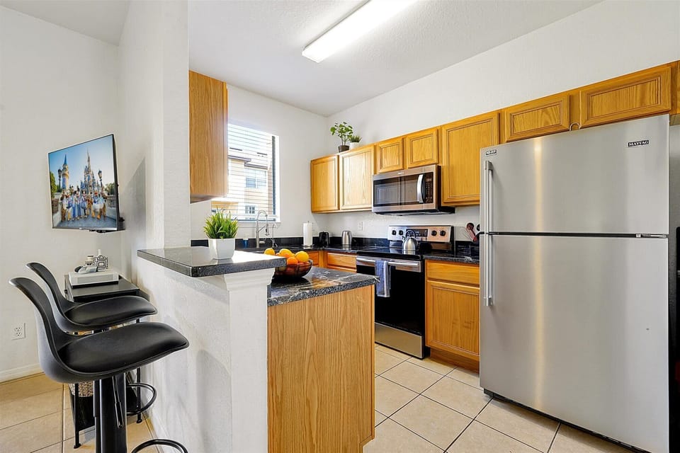 The bright kitchen has stainless steel appliances