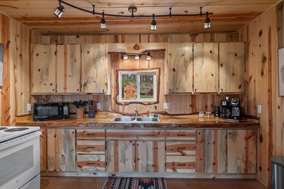 with cups, bowls, plates, mugs, silverware and every cooking utensil you’d need (including barbecue tools)!