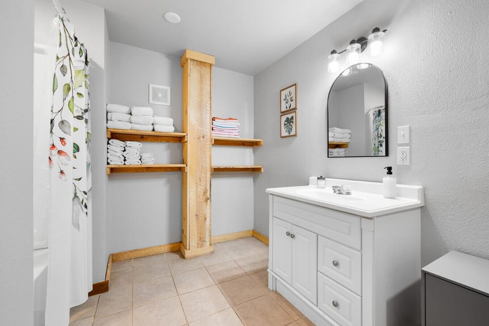 Bright and clean bathroom with a tub and roomy vanity.