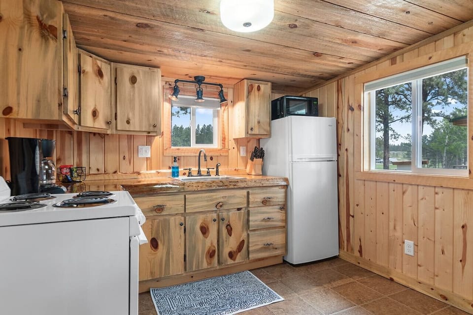 Kitchen Area with stove, refrigerator, kitchen stools, coffee maker, oven