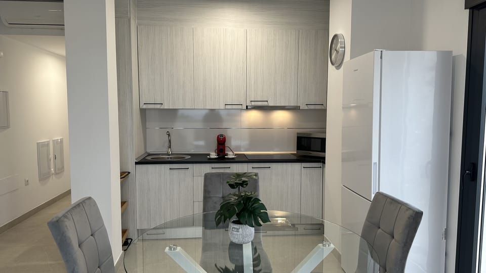 The well-equipped, semi-open kitchen has the necessary amenities