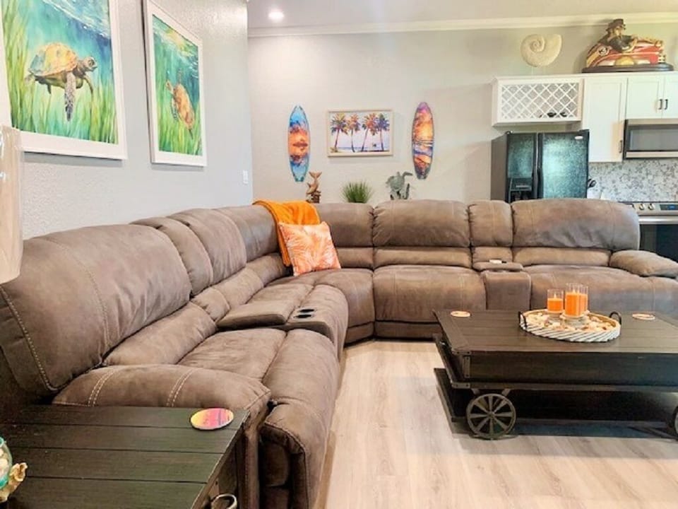 Sectional sofa with 4 reclining chairs, adjustable head rests & 2 storage areas